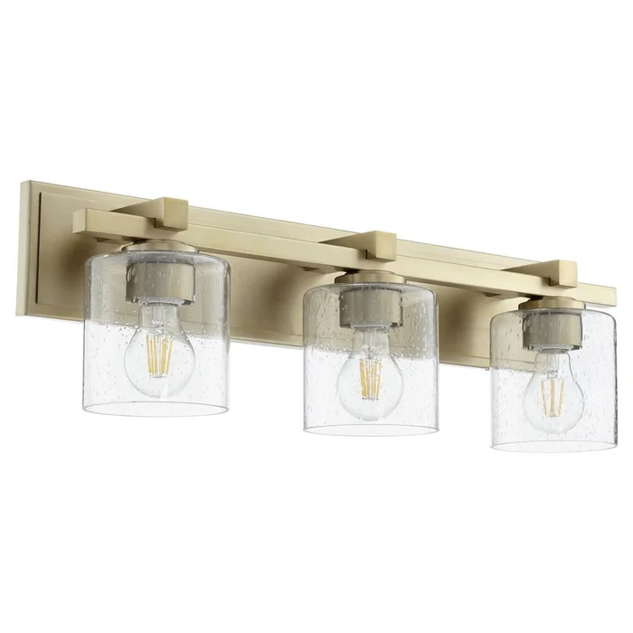 Quorum 3-LT Cylinder Bath Vanity Light – Aged Brass w/ Clear/Seeded – 5369-3-280